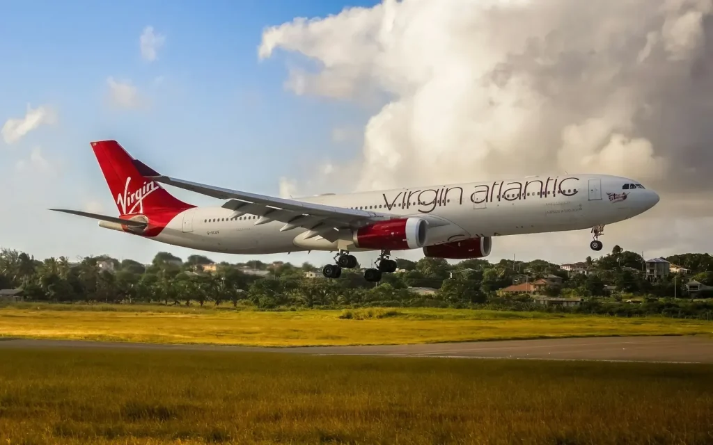 Airliner on final approach over a grass field