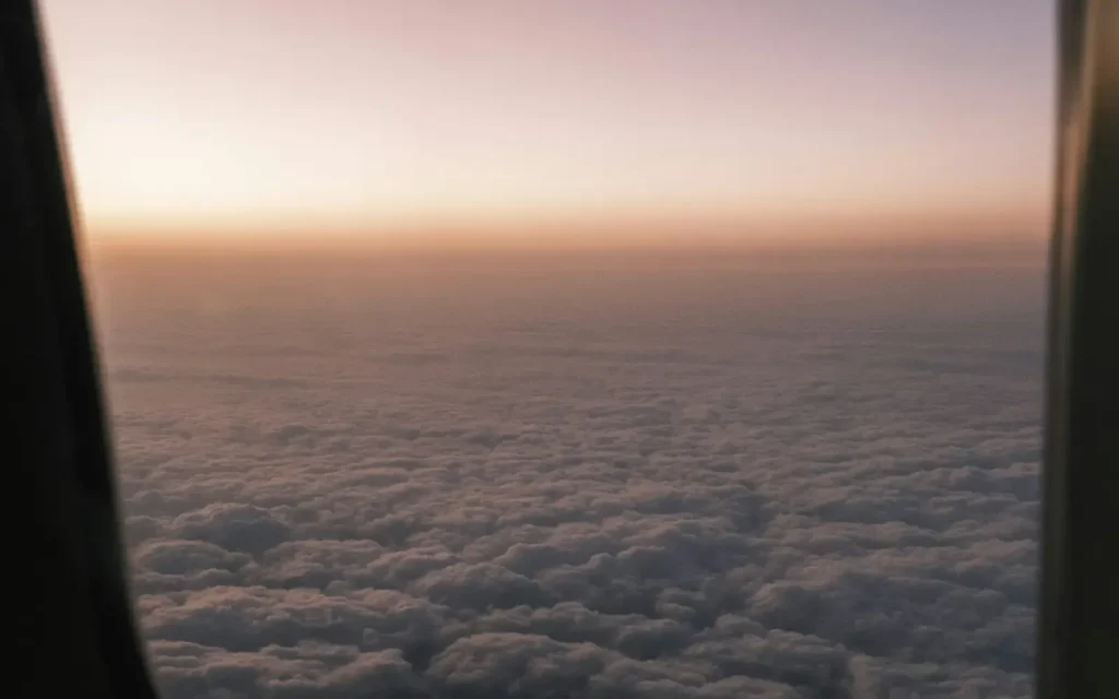 Clouds at sunset seen through an airplane window